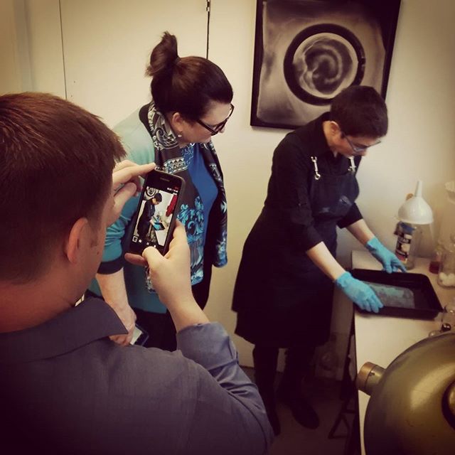 Wet Plate Collodion Photography at Genesee Libby Studio — Jenn washing the plate as workshop participants look on.