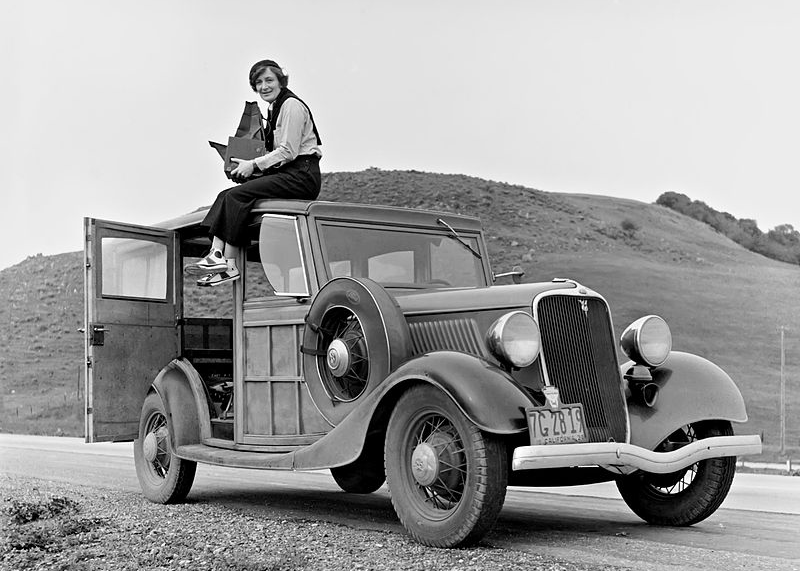Dorothea Lange photographing from the car roof with a Graflex RB Single Lens Reflex Camera